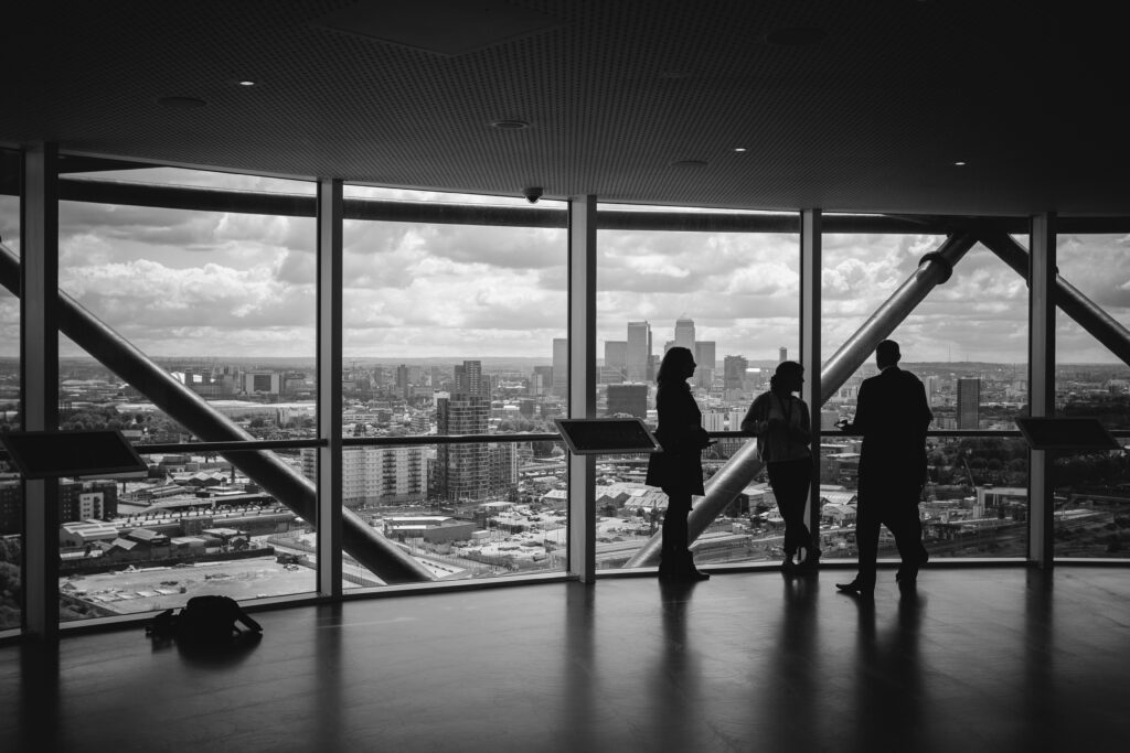 people standing inside city building people standing inside city building